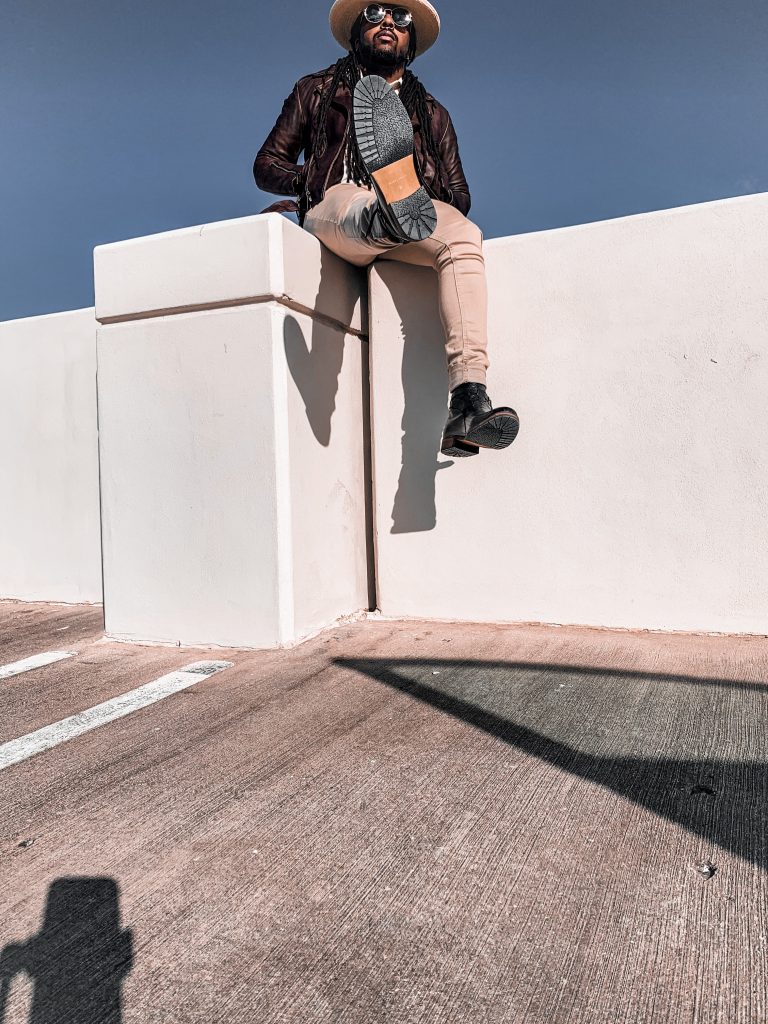 brown leather jacket, cream polo shirt with black chevron pattern, cream straw fedora, bone denim pants and black boots. 7 different ways to style Jodhpur boots!