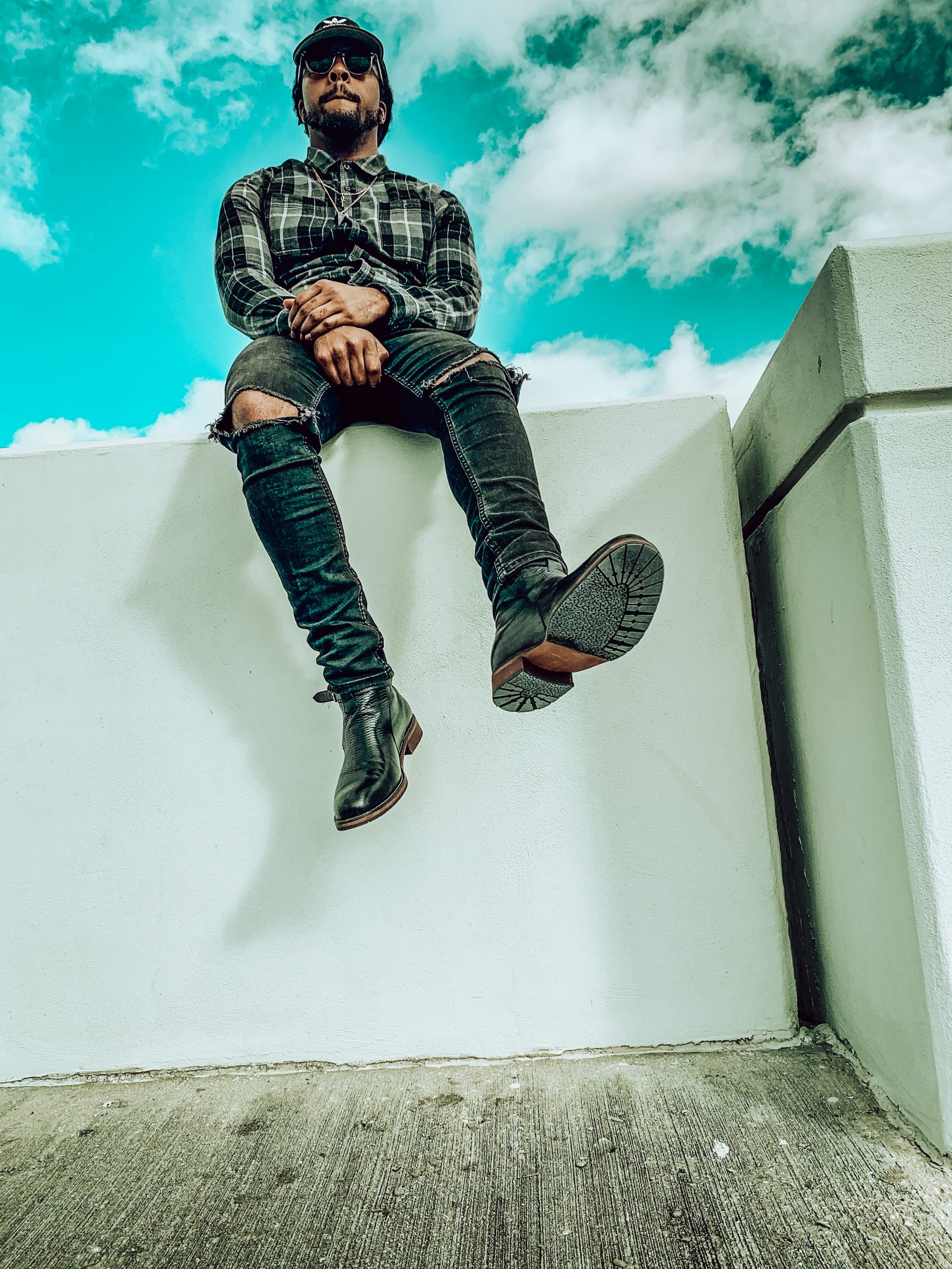 black checkered flannel shirt, black dad hat, black distressed denim, black jodhpur boot. 7 different ways to style Jodhpur boots!