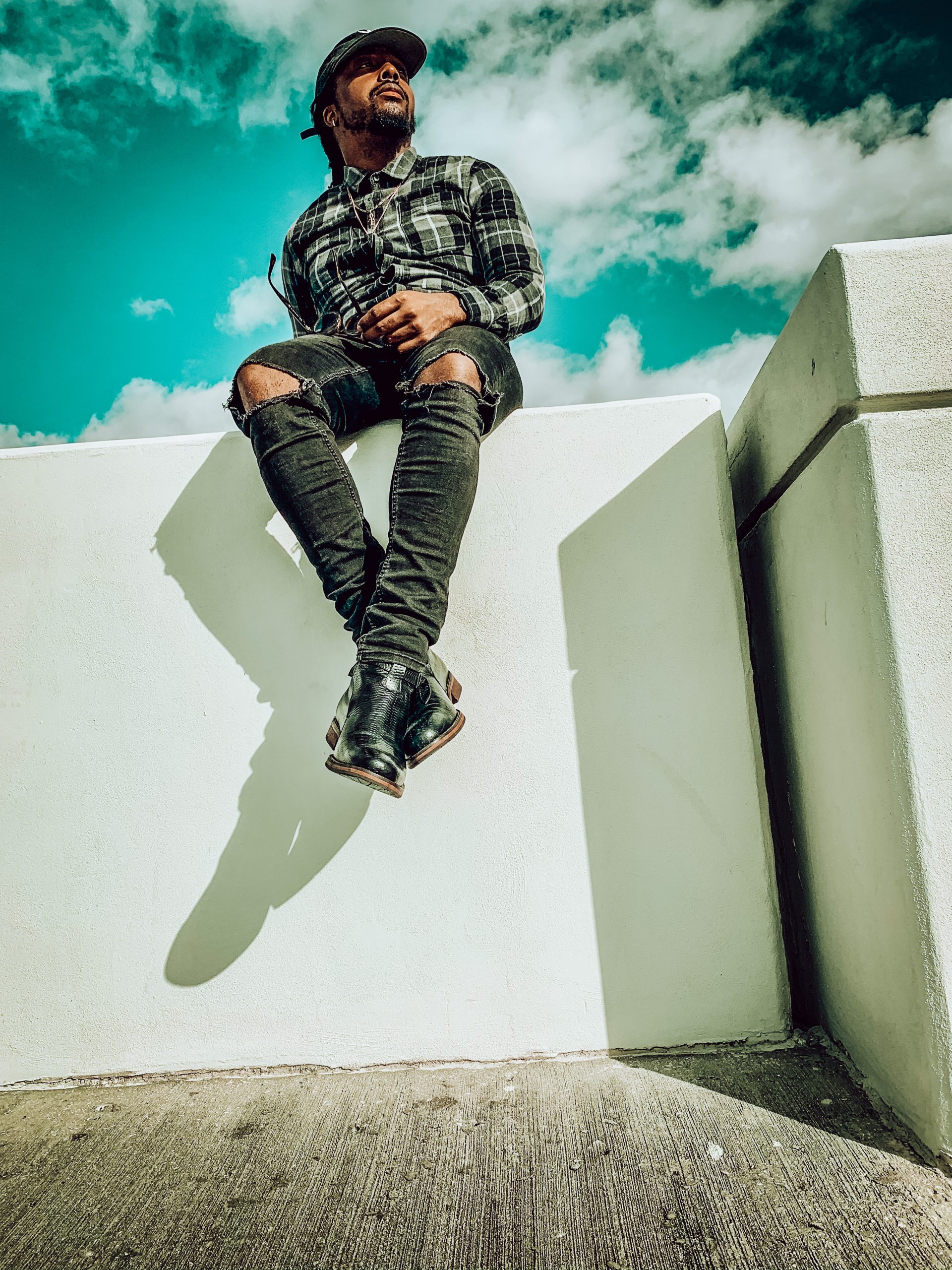 black checkered flannel shirt, black dad hat, black distressed denim, black jodhpur boot. 7 different ways to style Jodhpur boots!