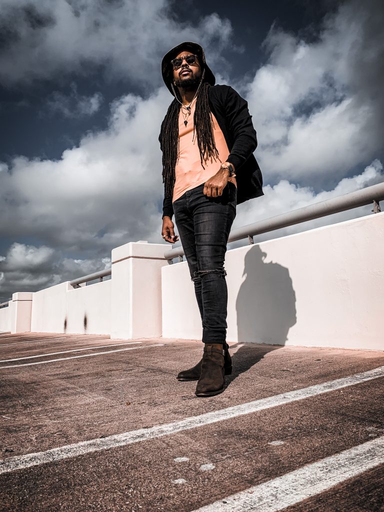 yellow v neck t shirt, black distressed denim, black cardigan, green camo bucket hat, olive green boots. 7 different ways to style Jodhpur boots!