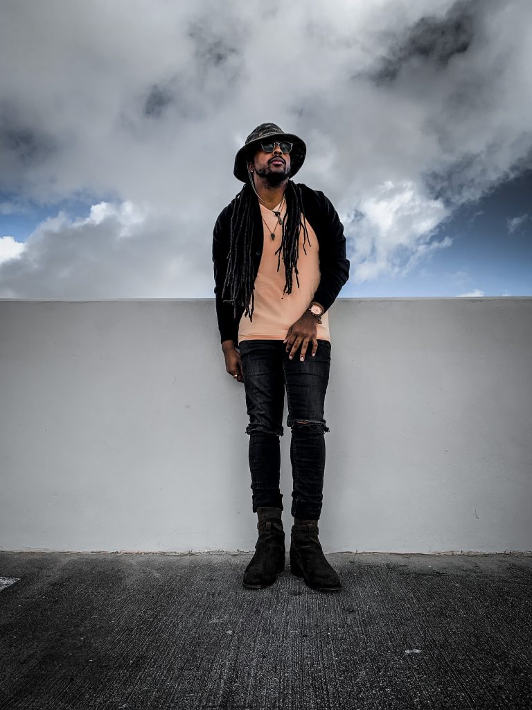 yellow v neck t shirt, black distressed denim, black cardigan, green camo bucket hat, olive green boots. 7 different ways to style Jodhpur boots!