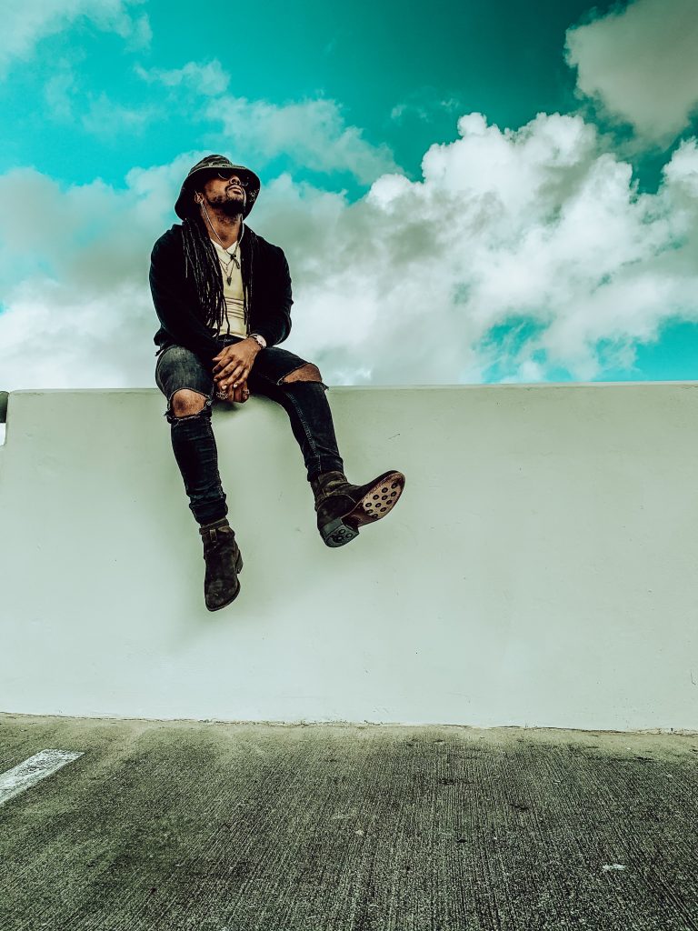 yellow v neck t shirt, black distressed denim, black cardigan, green camo bucket hat, olive green boots. 7 different ways to style Jodhpur boots!